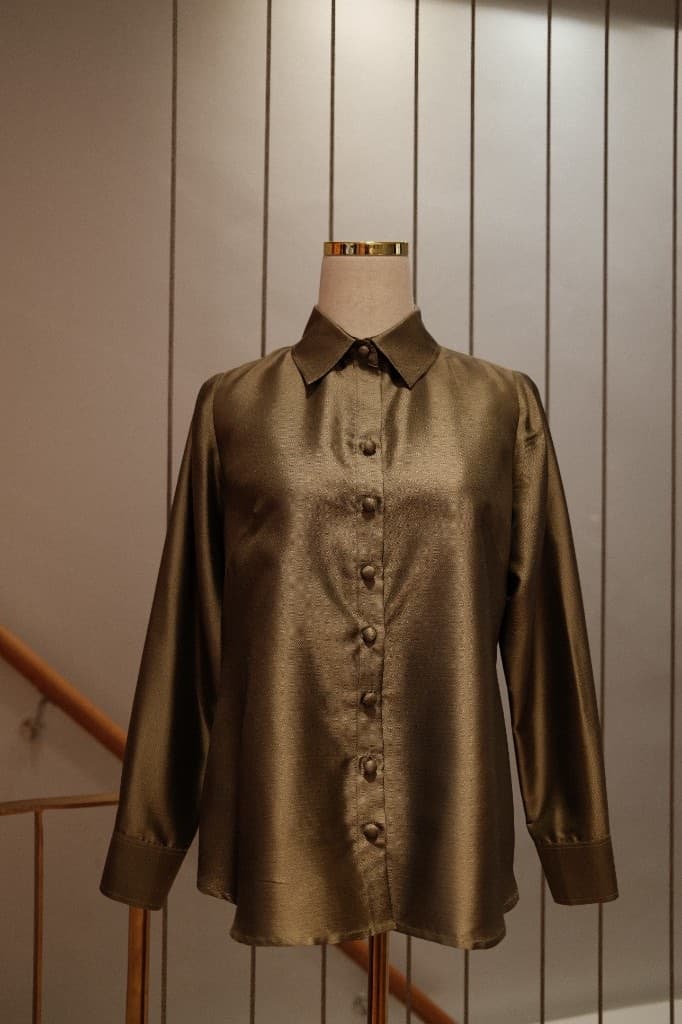 Custom tailored blouse in bronze-olive textured fabric with fabric covered buttons