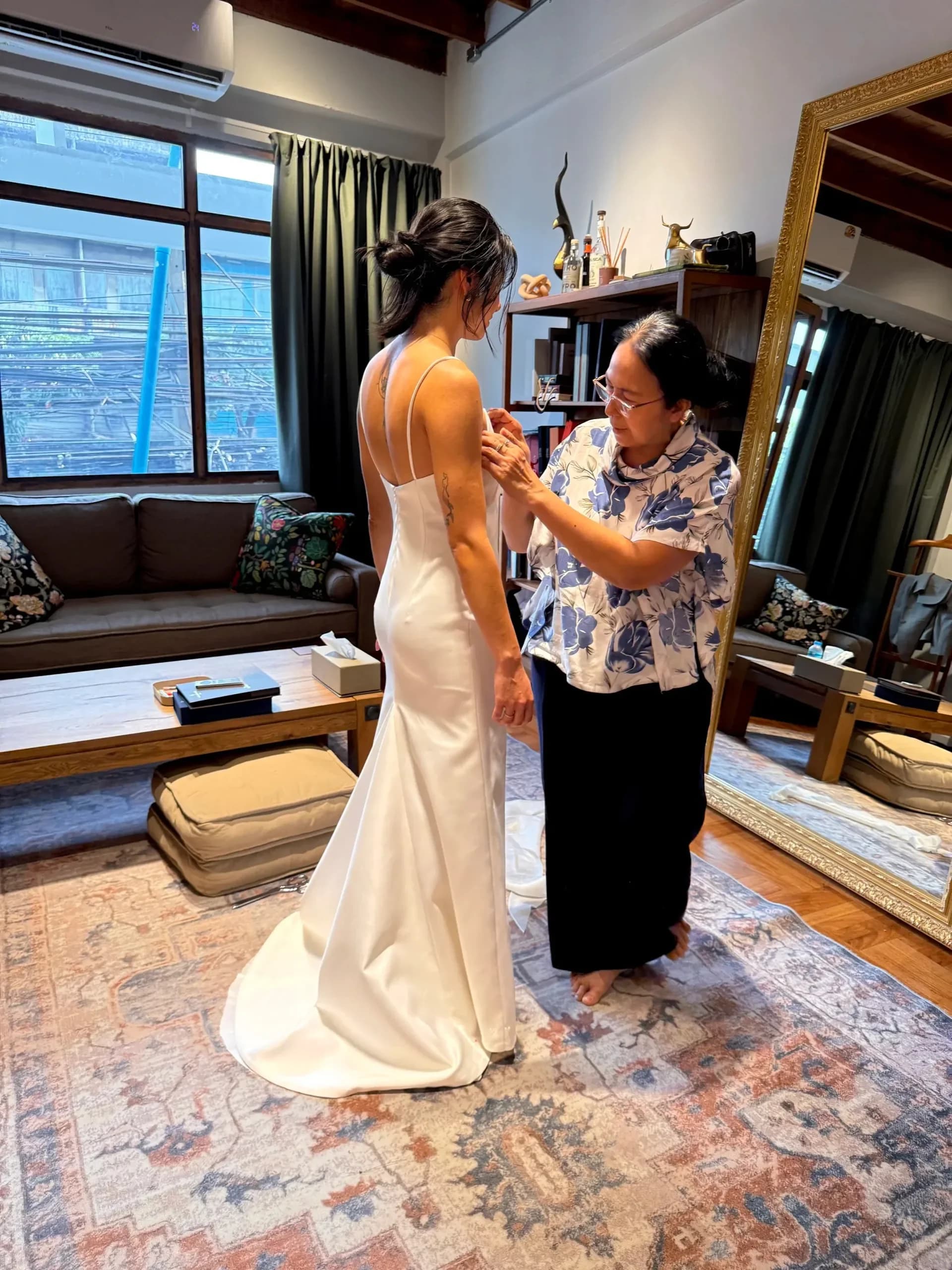 Bride at her fitting for a white minimal wedding dress at the LALEDA atelier